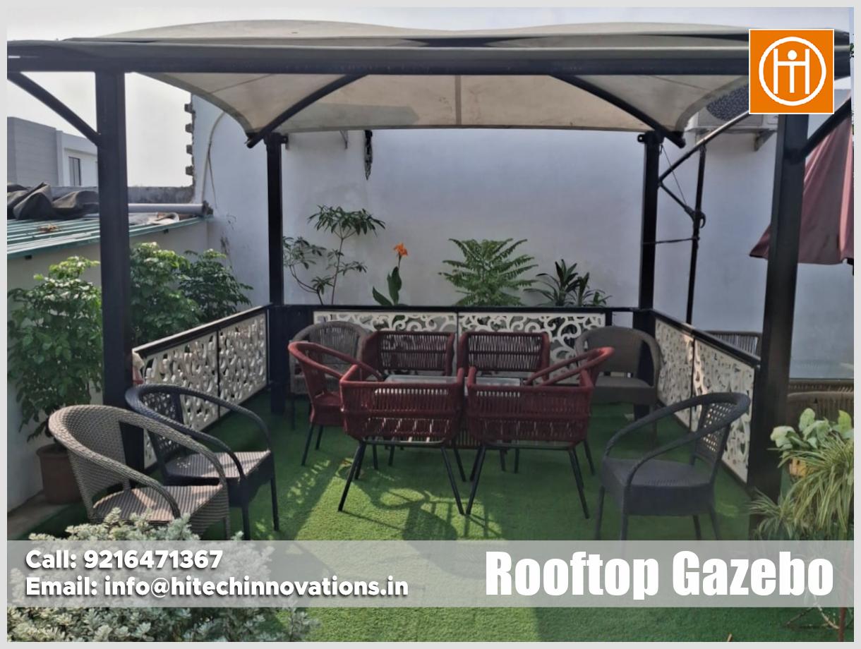 Rooftop garden area with lush potted plants, trees, and greenery surrounding the Hitech Innovations project site in Panchkula, Haryana.