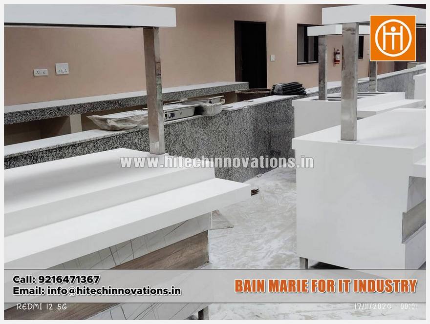 Perspective view of a long white food service counter for an IT company cafeteria, showing the sleek modern design and marble-textured side panels