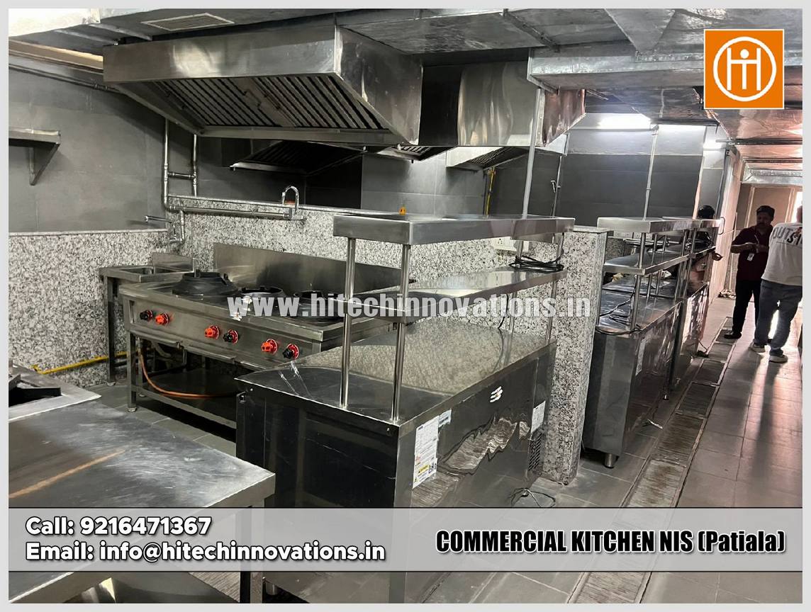 Wide view of the industrial kitchen installation at National Institute of Sports Patiala showing prep stations, stainless steel equipment, and ventilation systems.