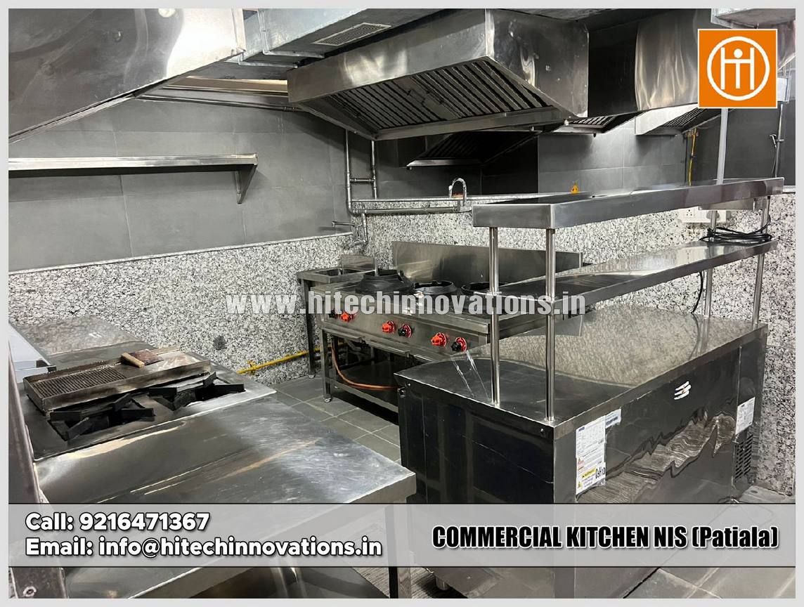 Professional commercial kitchen setup at NIS Patiala featuring stainless steel wok ranges, high-pressure burners, and industrial exhaust hoods by Hitech Innovations.