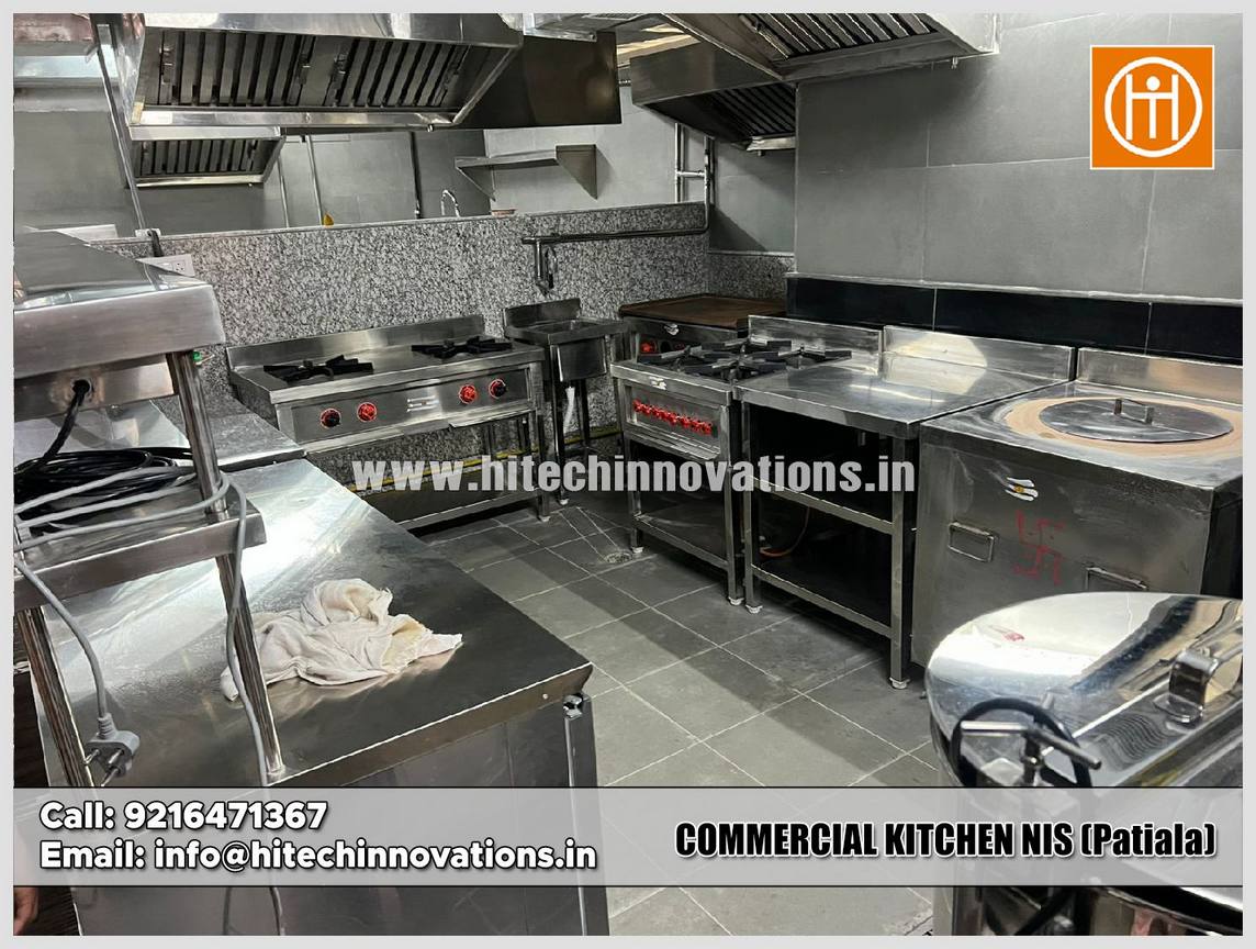 Stainless steel two-tier overhead pass-through shelving unit and worktable for efficient food service at the NIS Patiala commercial kitchen.