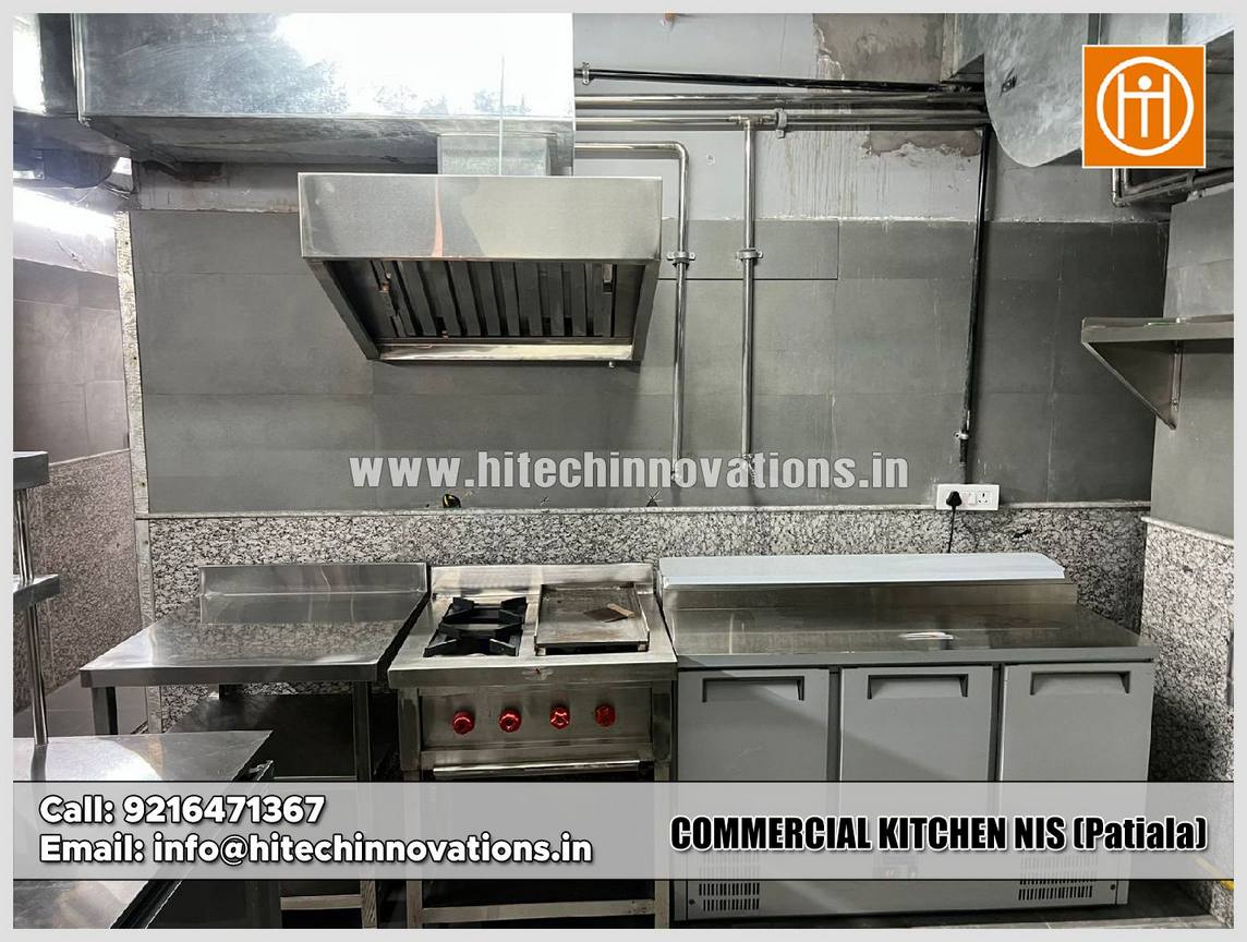 Comprehensive view of the cooking section at NIS Patiala including heavy-duty gas ranges, tandoors, and stainless steel washing sinks.