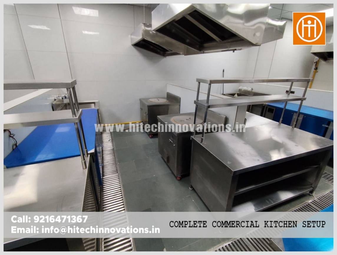 Spacious commercial kitchen layout at an IT facility in Haryana featuring industrial tandoors and custom stainless steel storage units.