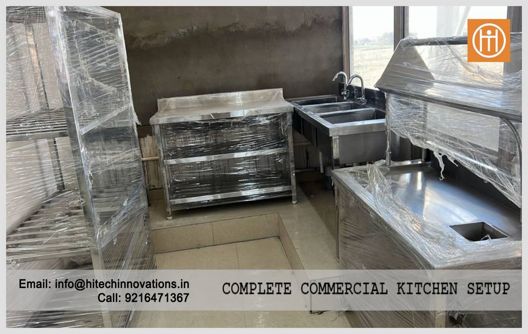 Professional three-sink wash station and stainless steel work tables installed at the PCA Stadium commercial kitchen