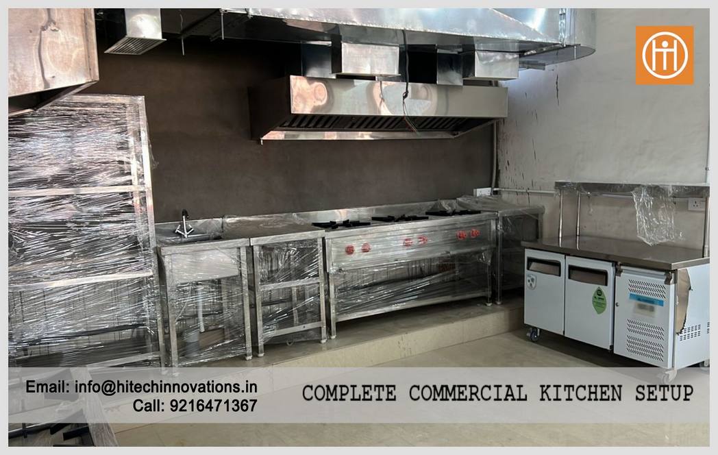 Commercial cooking range with high-pressure burners, exhaust hood, and under-counter refrigeration at the PCA Stadium kitchen