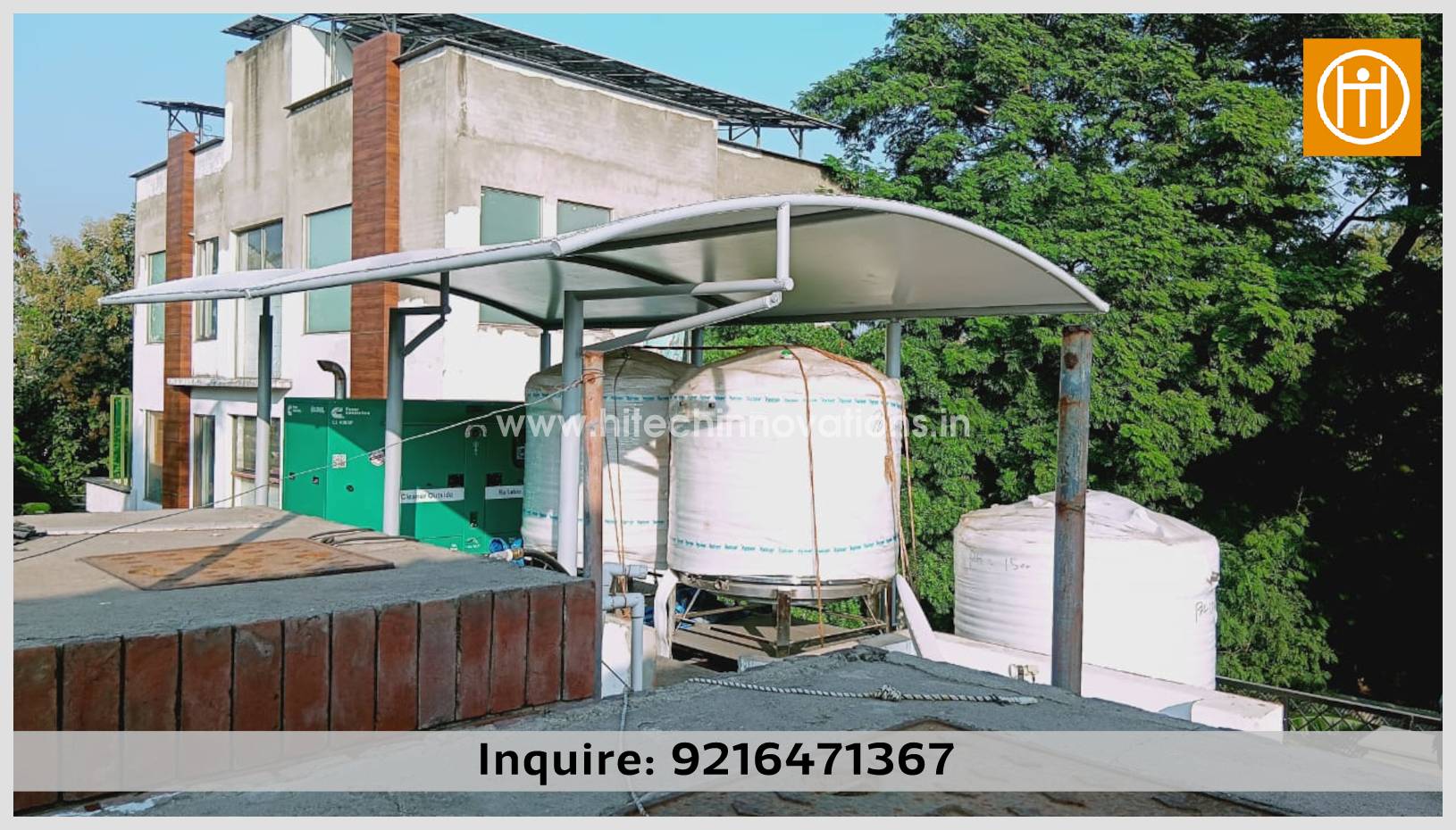 Close-up side profile of a modern cantilevered tensile shade by Hitech Innovations, showing the sleek white fabric and robust steel frame protecting water tanks on a commercial building roof.