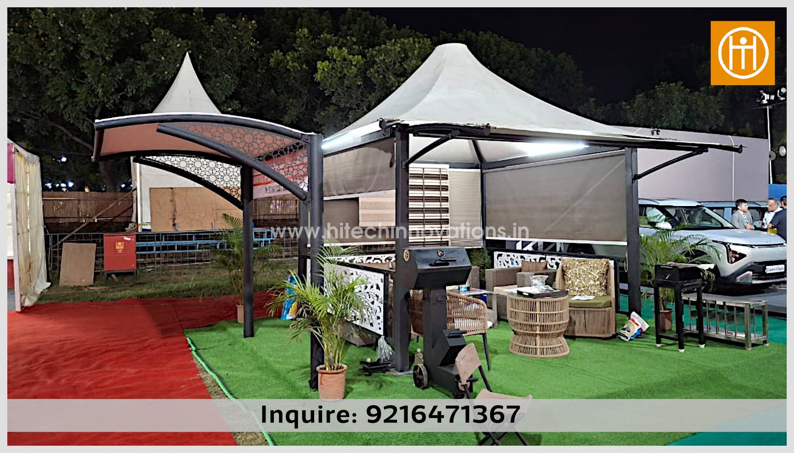 An outdoor exhibition display by Hitech Innovations at CII featuring a modern conical tensile gazebo with an integrated patio furniture set and an adjacent curved tensile car parking shed.
