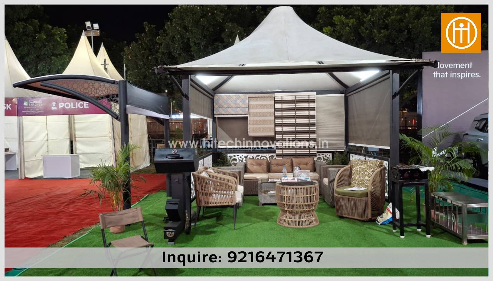 Frontal view of a premium Hitech Innovations gazebo at the CII exhibition, showcasing weather-resistant blinds, luxury outdoor seating, and a sleek black tensile car shed structure to the side.