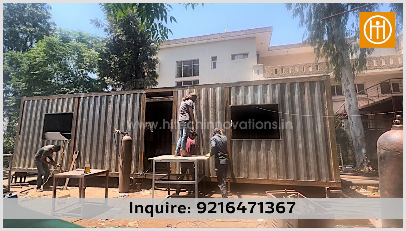 Installing corrugated metal side walls on a luxury container home at the Hitech Innovations manufacturing facility in Mohali.