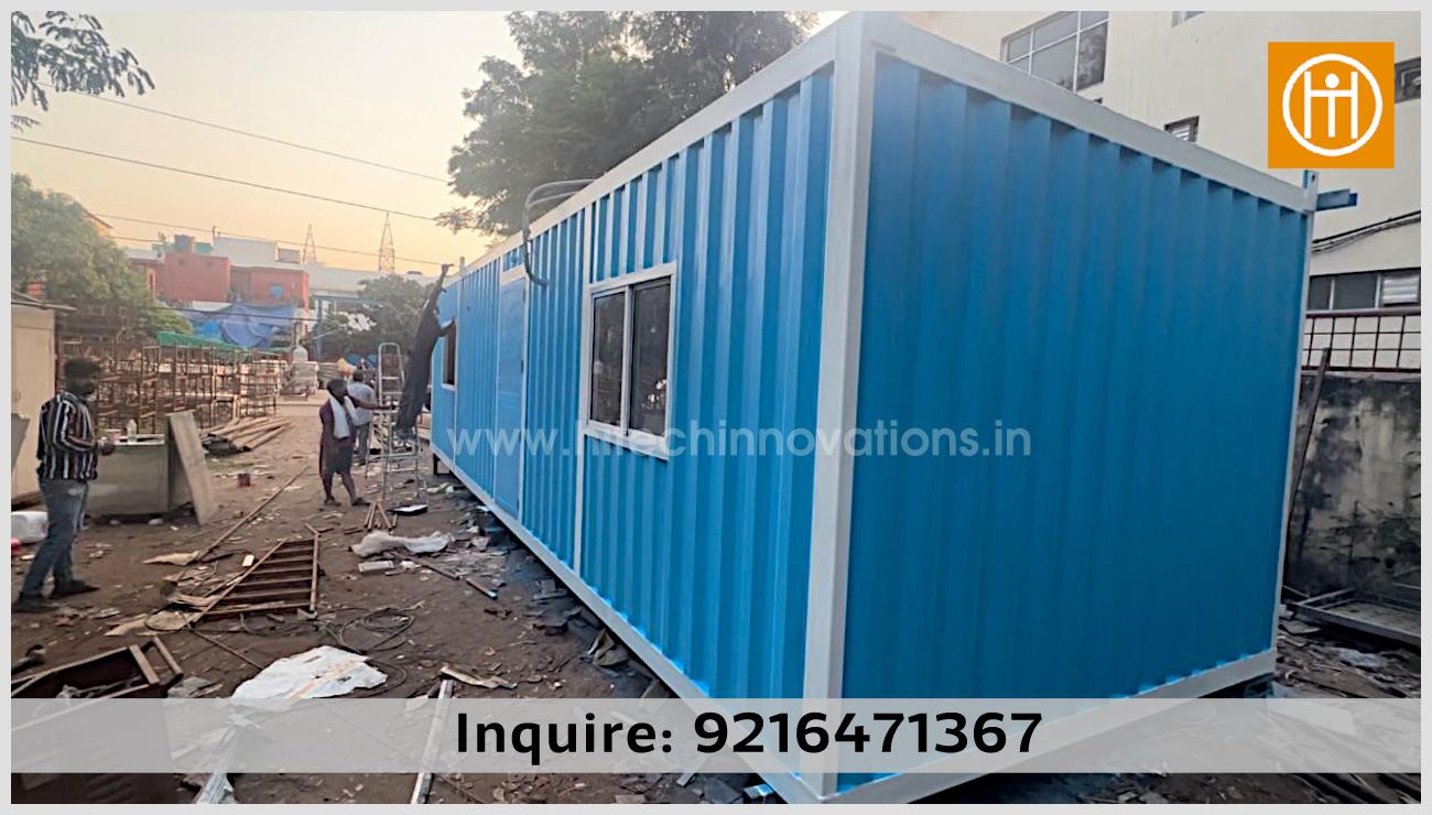 A completed blue prefabricated container home by Hitech Innovations Mohali, featuring white trim and sliding windows, ideal for a farm house, site office, or tiny home.