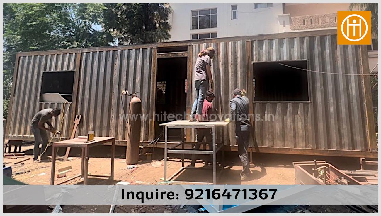 Hitech Innovations team in Mohali fabricating a steel container home, showing the structural modifications for windows and doors for a custom restaurant or honeymoon suite.