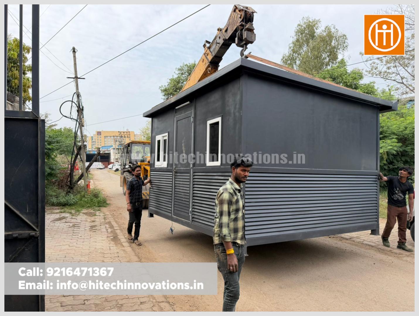 Side view of a prefabricated security cabin showing high-quality white-rimmed sliding windows being positioned on a transport vehicle.