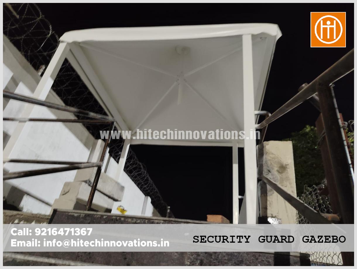 Under-roof view of a security gazebo showing the interior frame and lighting installation.