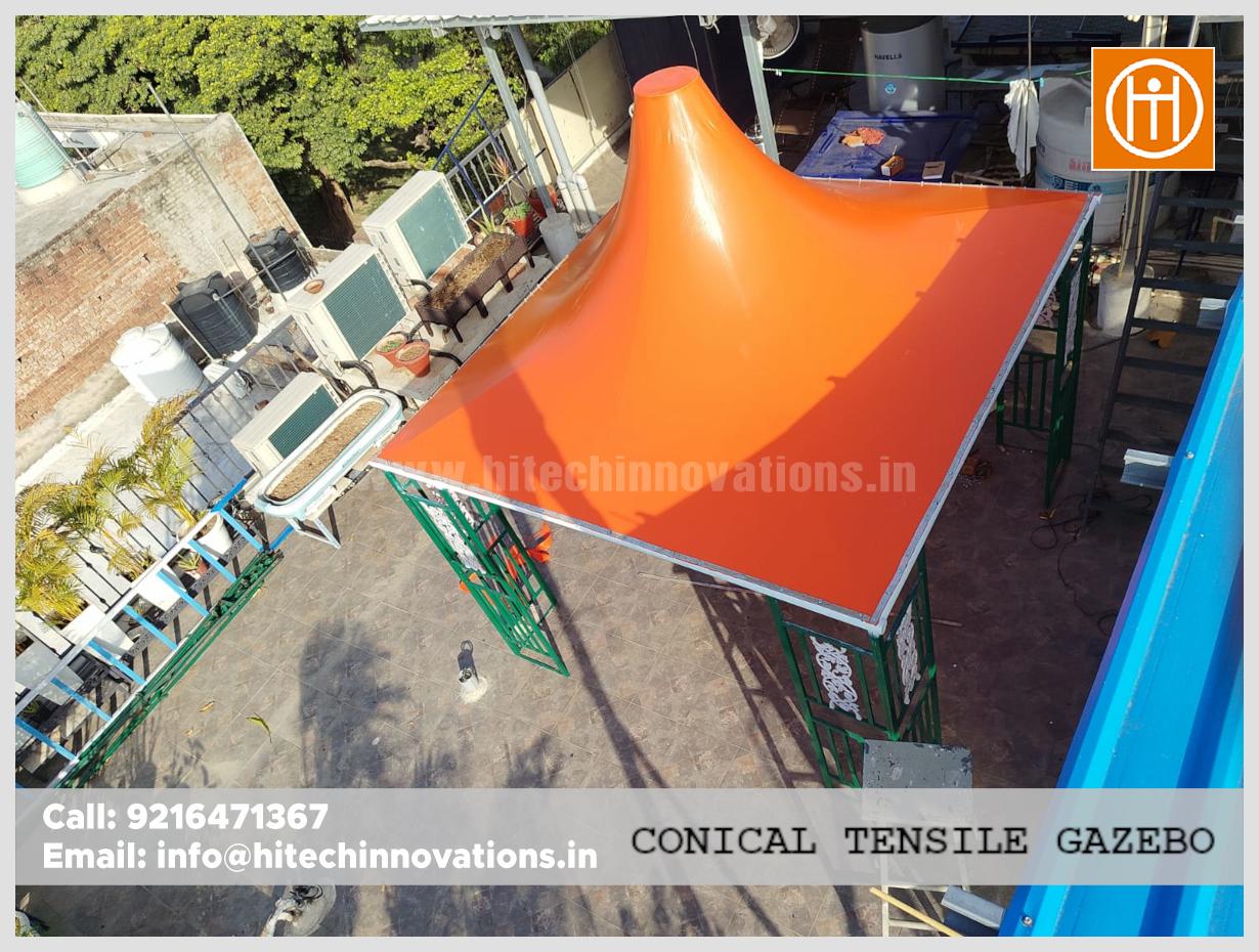 Top view of an orange conical tensile gazebo installed on a rooftop sitting area by Hitech Innovations.