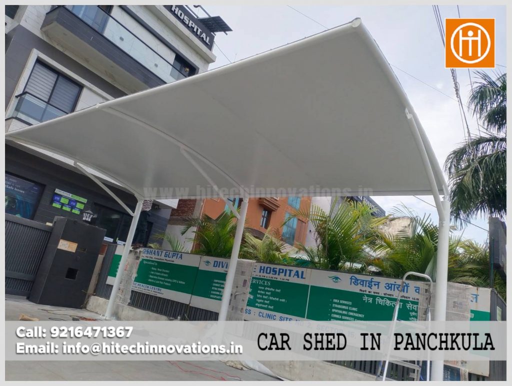 Modern white tensile fabric car parking shed installed at Divine Eye Hospital in Panchkula by Hitech Innovations.