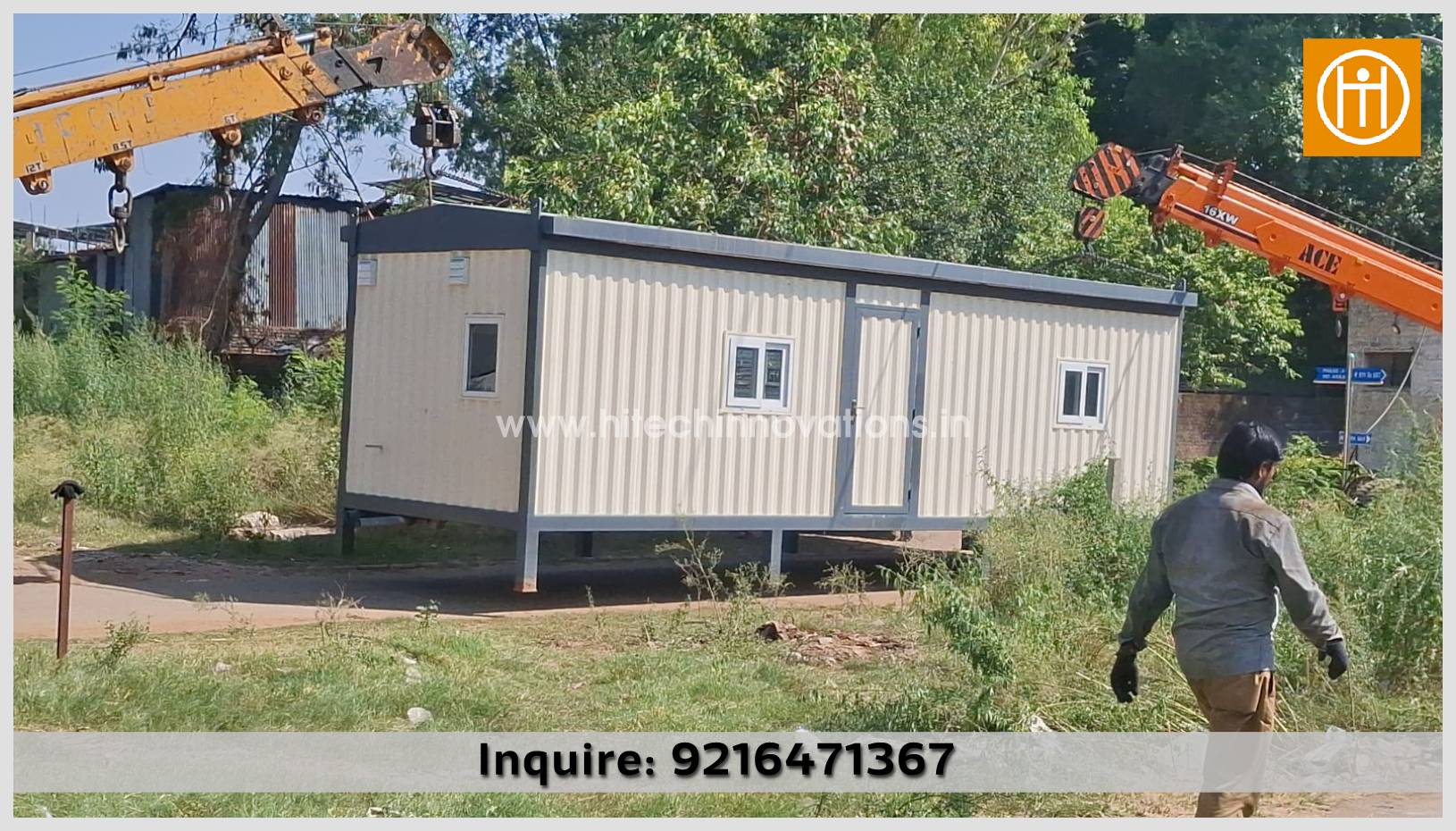 An employee from ISO 9001:2015 certified Hitech Innovations, the foremost manufacturer of container homes in India, moves around a cozy office-cum-residential container featuring two rooms, a toilet, and a pantry, while a crane positions it at the site.