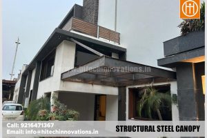 Side view of a newly installed structural steel canopy on a modern home facade.
