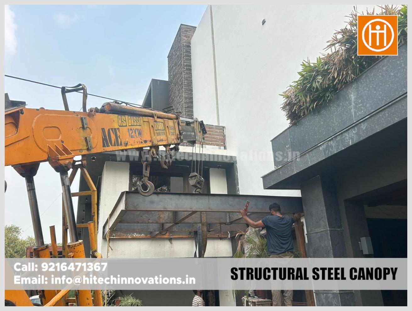 A technician leveling a steel canopy frame during the installation process.