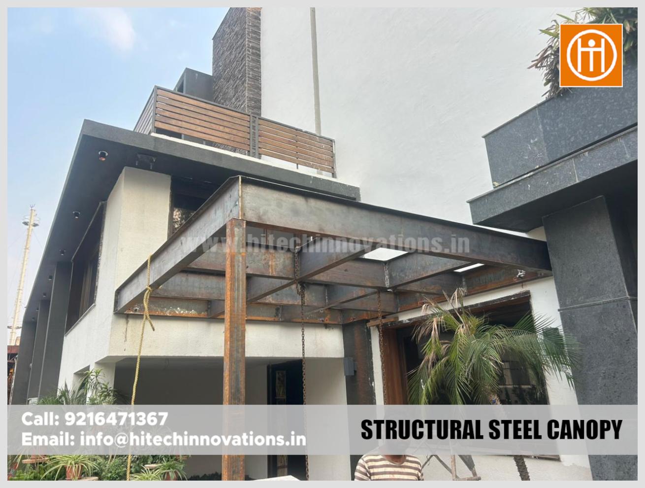 Completed structural steel canopy frame mounted on a building exterior.