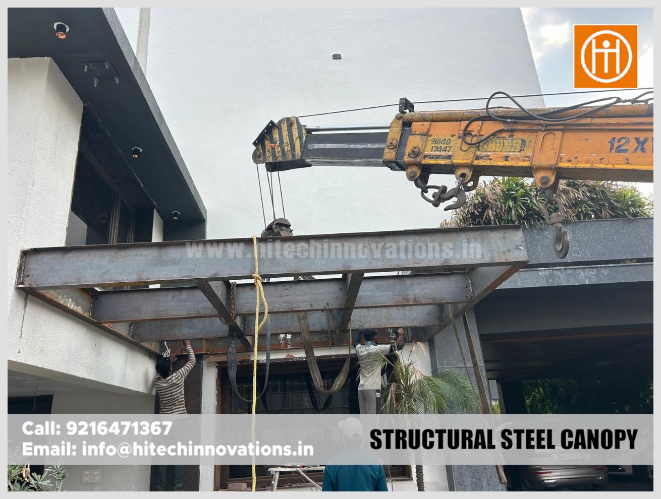 Precision installation of a structural steel canopy frame for an entrance porch.