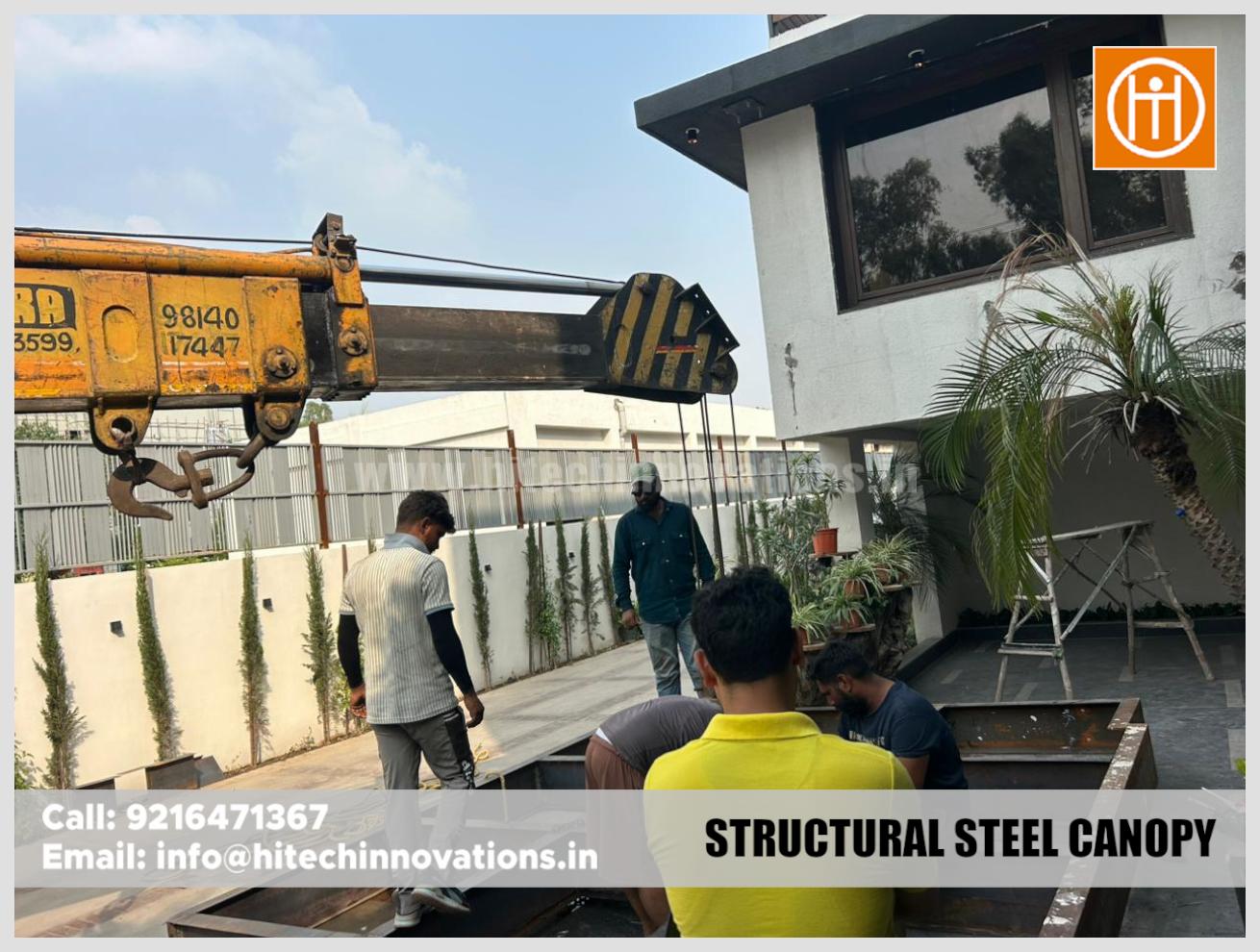 Construction team working on a custom structural steel canopy installation for a residential project.