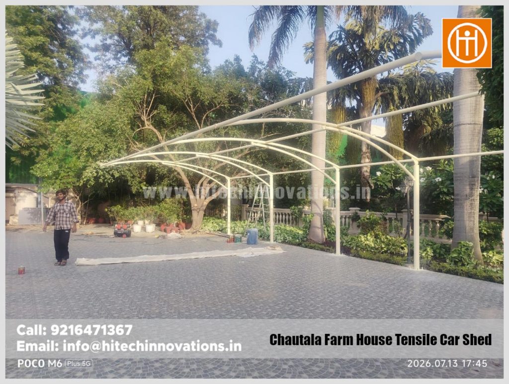 Work-in-progress on the structural frame of a large tensile parking shed for multiple vehicles.