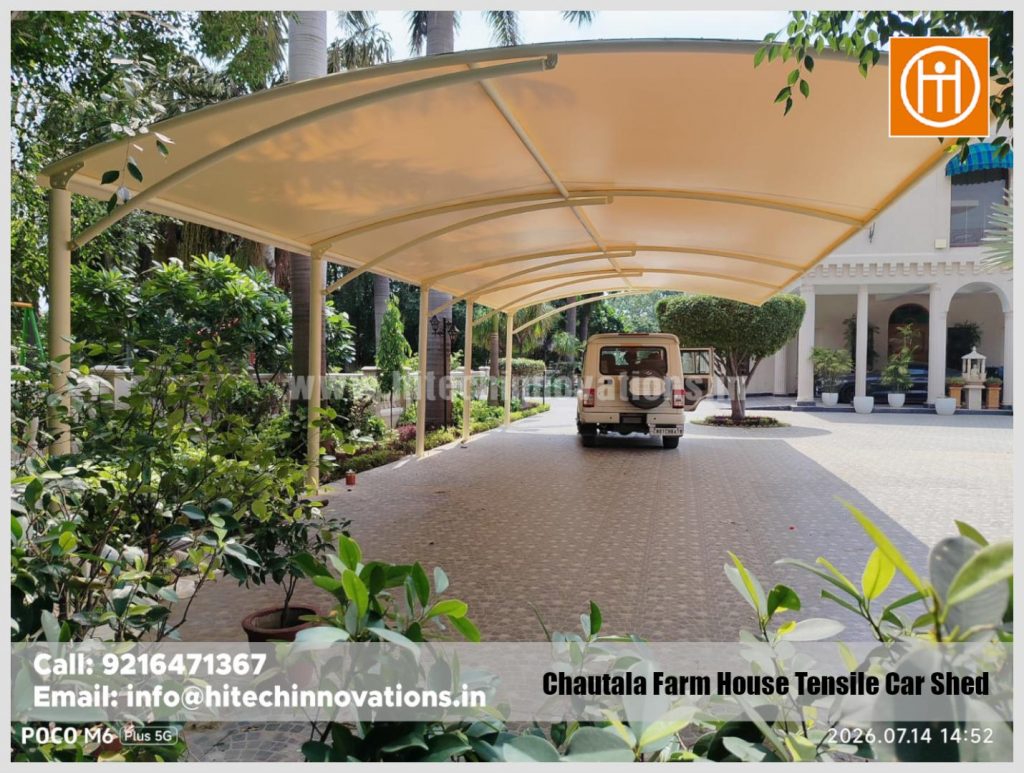 Wide angle view of the elegant tensile shed covering the parking area of a farmhouse.