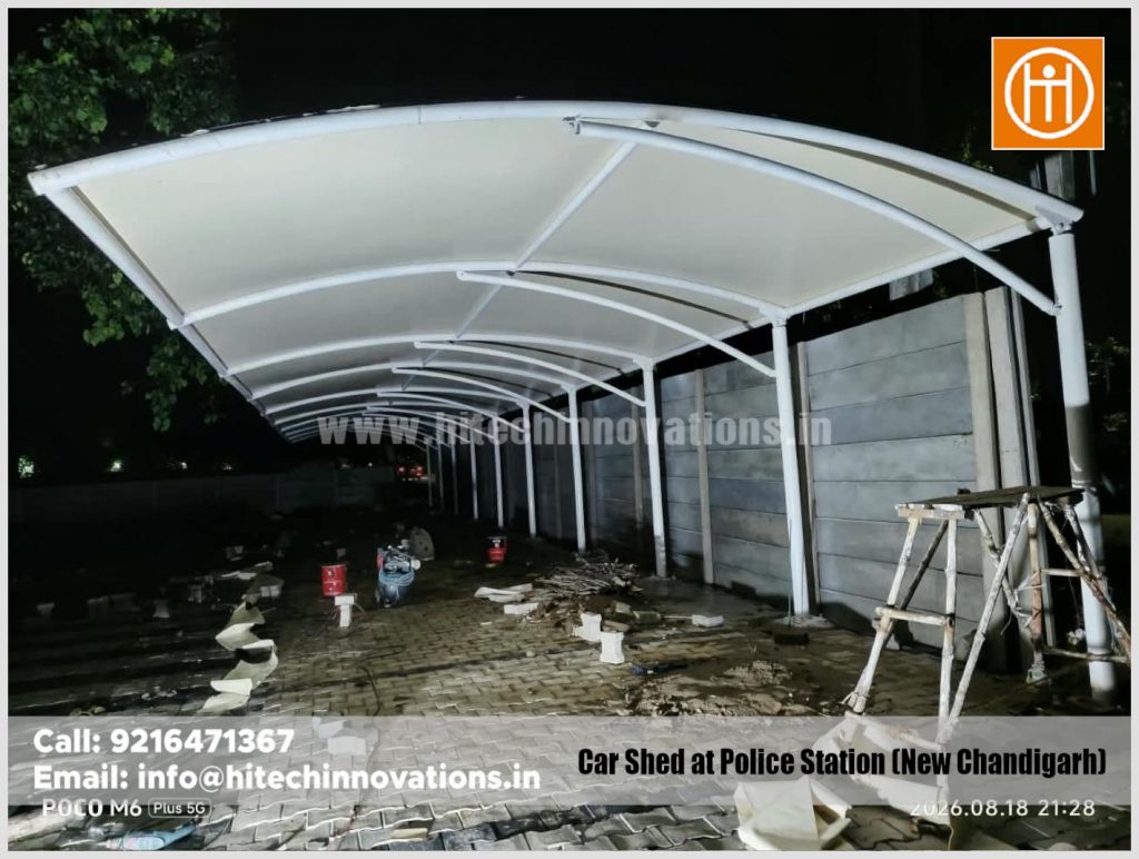 Night view showing the successfully installed architectural tensile fabric covering the curved steel framework.