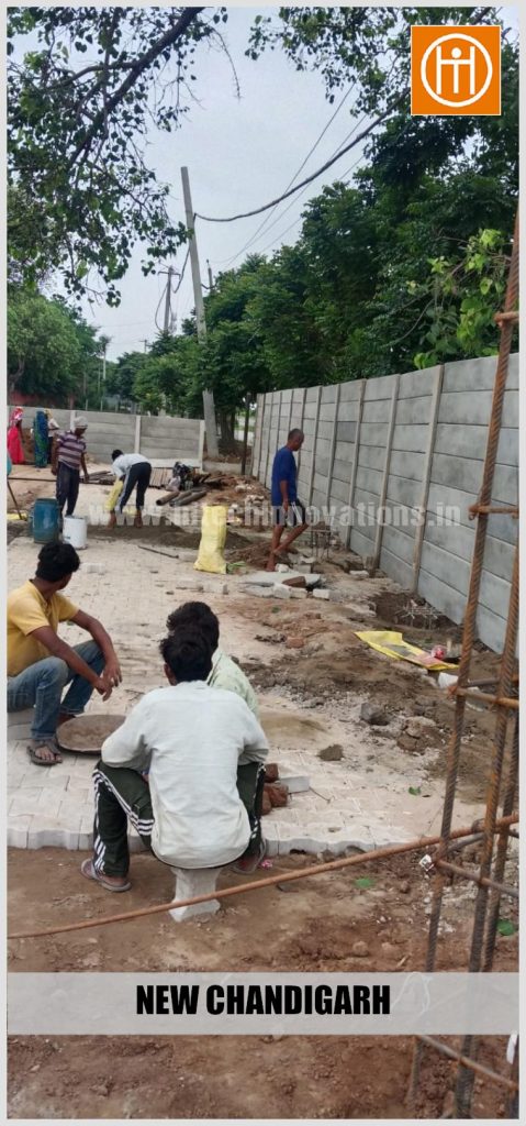 Workers taking a break amidst ongoing civil work and material staging at the New Chandigarh site.