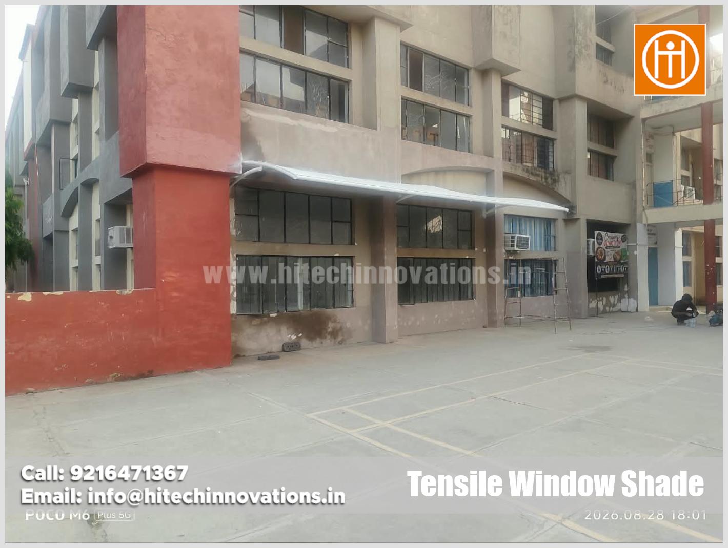 Side angle view of high-quality tensile window shade structure on university building facade by Hitech Innovations