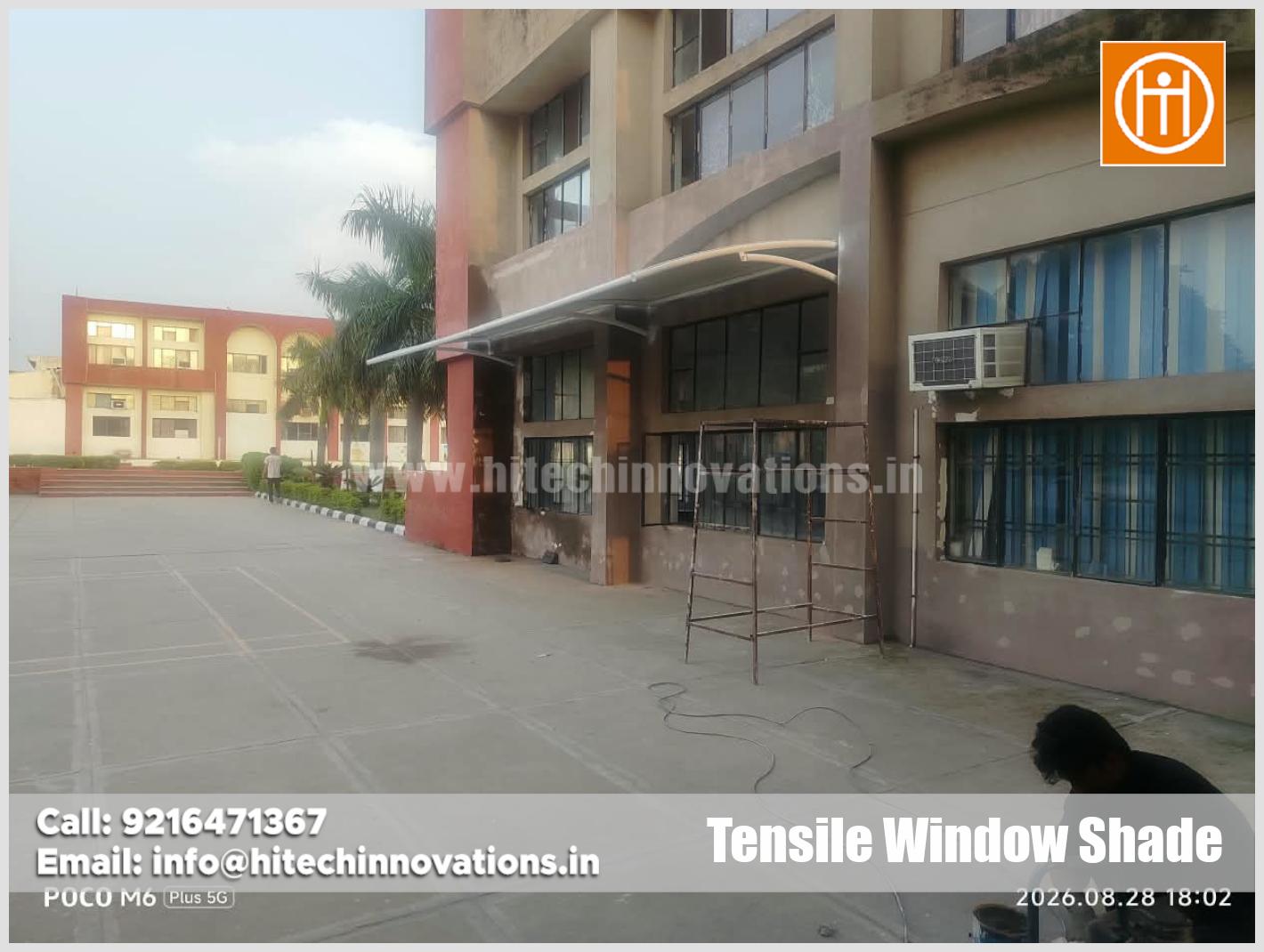 Exterior view of expertly engineered tensile window shade installed along campus corridor by Hitech Innovations Mohali