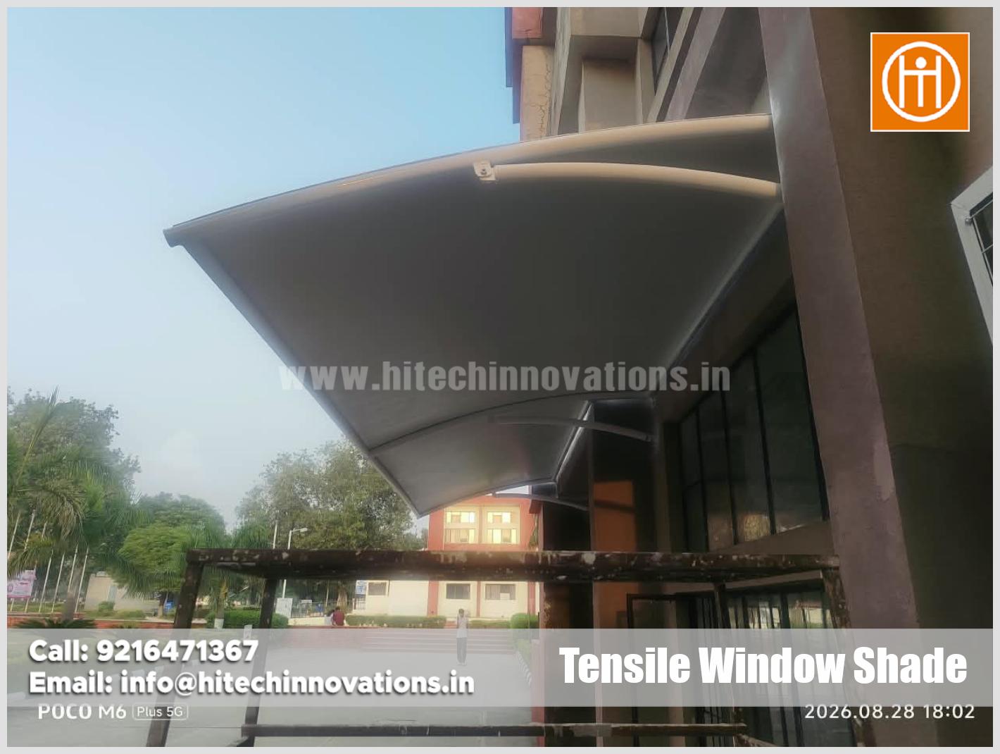 Close-up detail of premium tensile fabric membrane and structural steel framework on university window shade