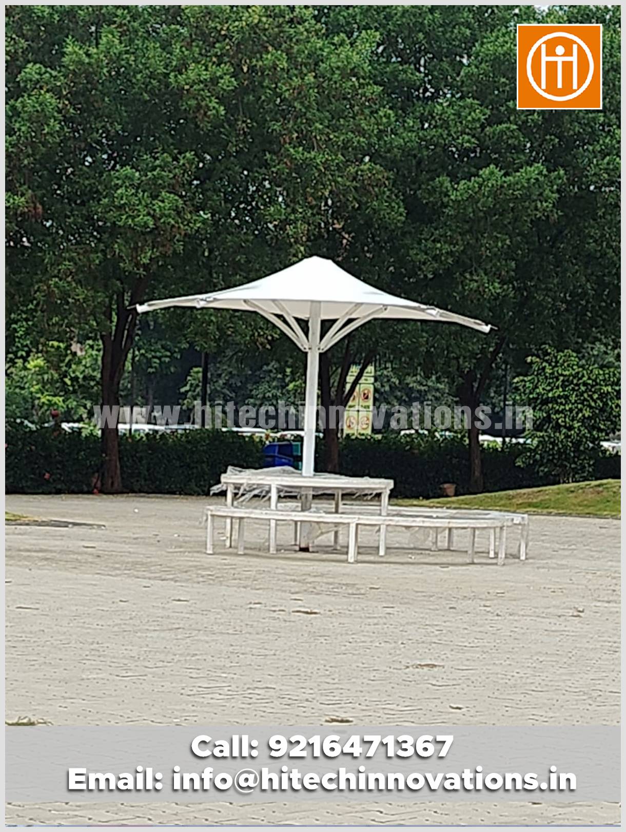 Tensile conical umbrella installed at Lovely Professional University (LPU), featuring attached seating and tables for students.