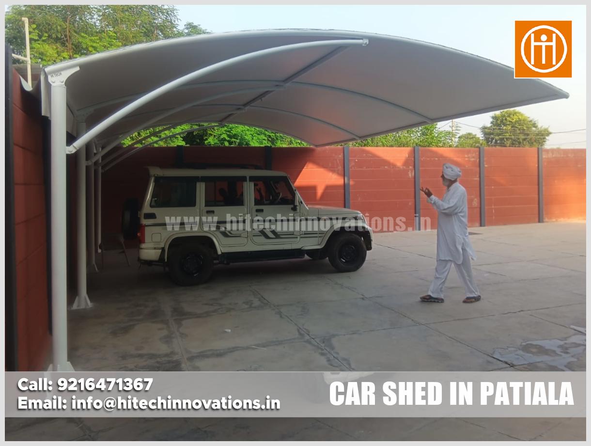 Wide angle view of structural tensile car parking shed with SUV parked underneath