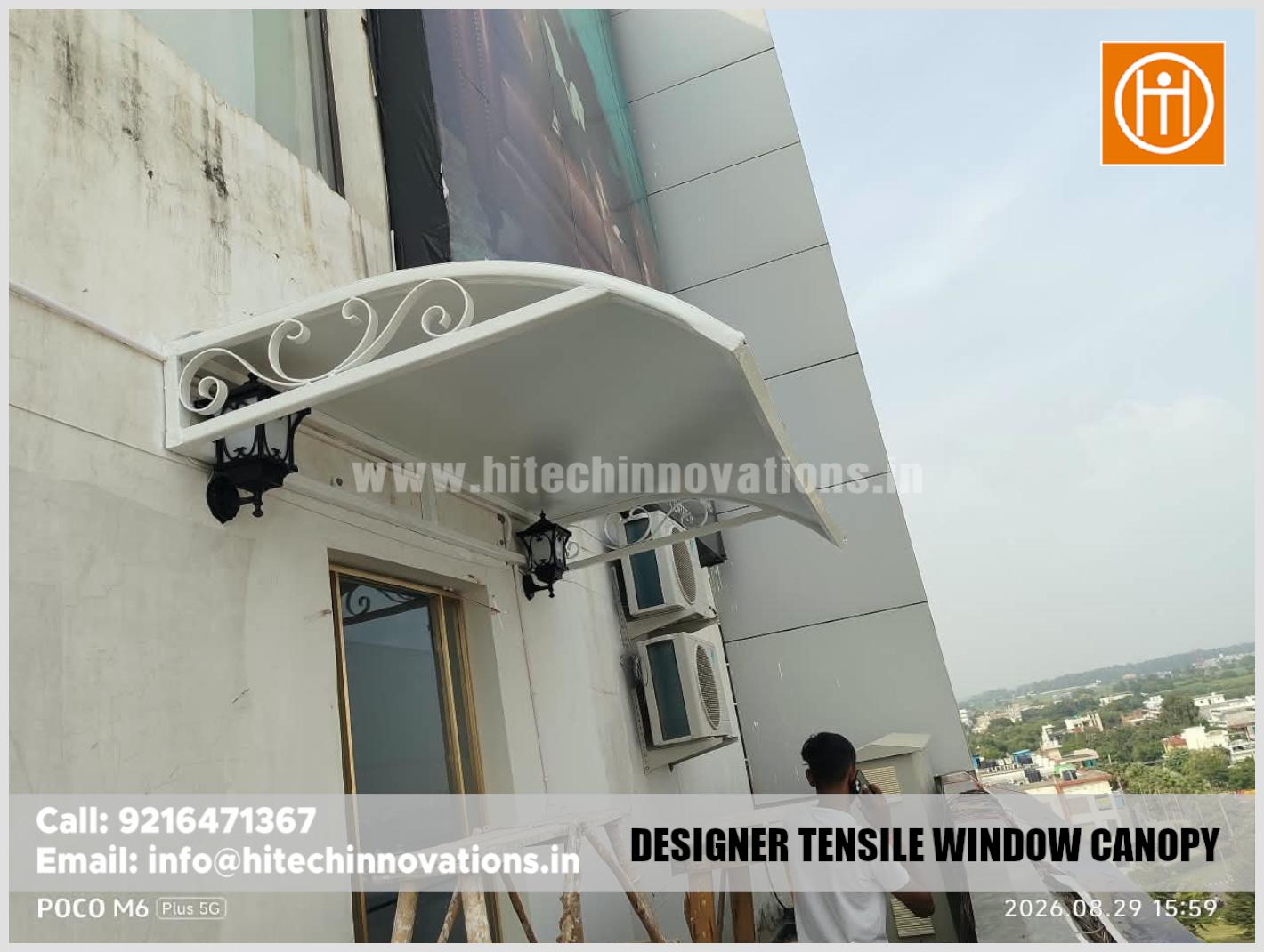 Low angle view of a white designer tensile window canopy installed at a building in Aerocity Mohali by Hitech Innovations