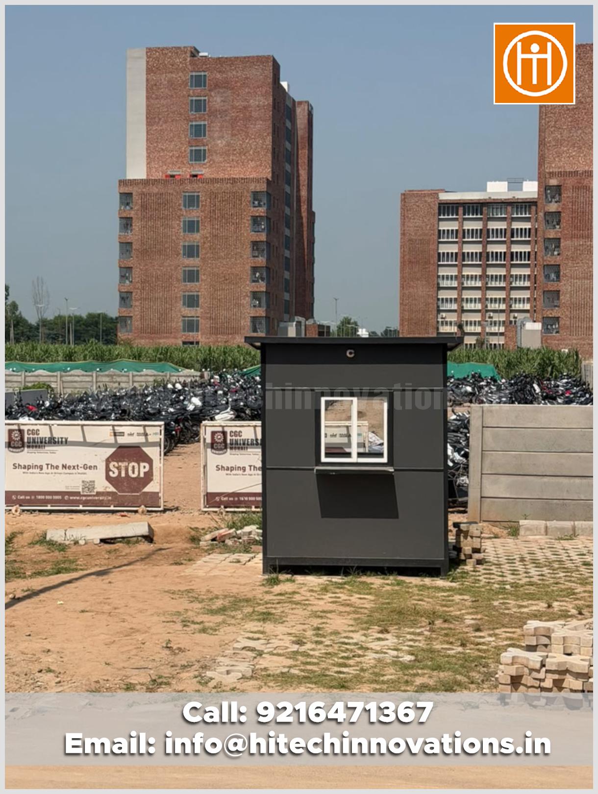Close-up view of a prefabricated security guard cabin manufactured by Hitech Innovations for CGC University, Mohali, set against a parking area and campus architecture.