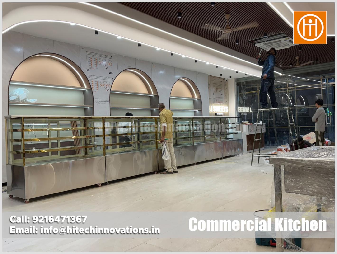 Custom glass sweet display counters and bakery showcase installation at J Sweets confectionery shop manufactured by Hitech Innovations